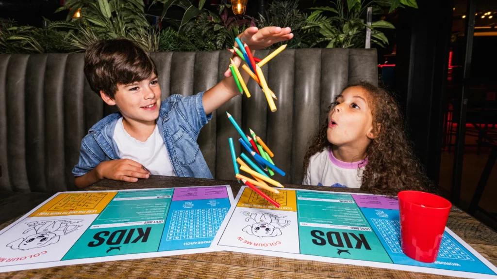 Two children playing with colouring sheets and pencils at BrewDog Waterloo.