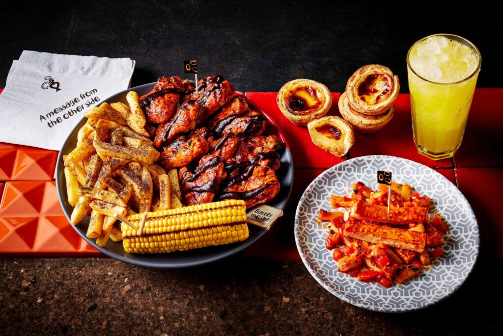 Nando’s Halloween menu featuring Phantom Wings, Tombstone Chips, HalloOoOoOomi Sticks, Toffee Apple Natas, and a drink.